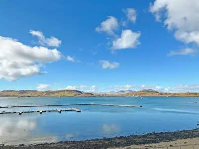 a large body of water with mountains in the background at Bay View in Oban