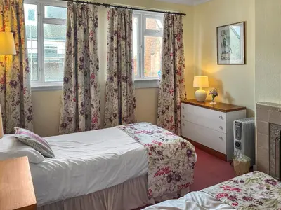 a bedroom with two beds and a window at Bay View in Oban