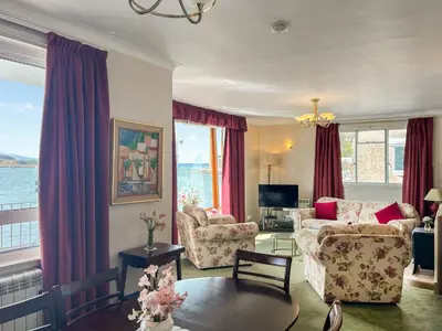 a living room with a couch and a table at Bay View in Oban