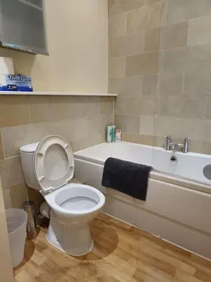 a bathroom with a toilet and a bath tub with a sink at 2 Bedroom Modern stylish Apt in Glasgow City Centre in Glasgow