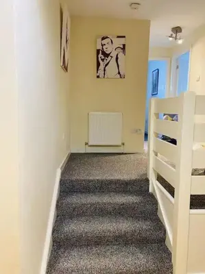 a staircase in a room with a white stair case at 2 Bedroom Modern stylish Apt in Glasgow City Centre in Glasgow