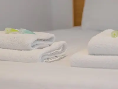 two towels with a bird sitting on top of them at Stylish West End Detached Mews - Pass the Keys in Glasgow