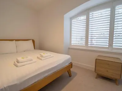 a bedroom with a bed with two towels on it at Stylish West End Detached Mews - Pass the Keys in Glasgow