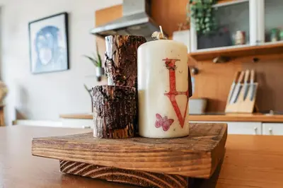 a candle sitting on top of a wooden table at Luxury Huge Modern Open Plan 2Bedroom Flat - Free Private Parking & Balcony located at the OVO Hydro and SEC Centre in Glasgow