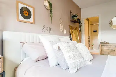 a bedroom with a white bed with white pillows at Luxury Huge Modern Open Plan 2Bedroom Flat - Free Private Parking & Balcony located at the OVO Hydro and SEC Centre in Glasgow