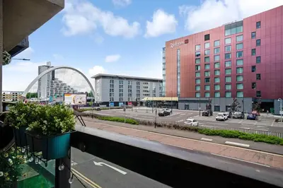 a view of a street in a city with buildings at Luxury Huge Modern Open Plan 2Bedroom Flat - Free Private Parking & Balcony located at the OVO Hydro and SEC Centre in Glasgow