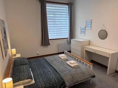 a bedroom with a bed and a desk and a window at Ben Lomond Apartment - Macaulay Letting in Alexandria