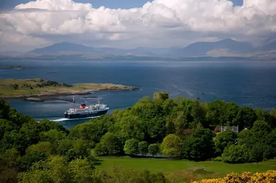 a large boat in a large body of water at Appin Holiday Homes -Caravans, Lodges, Shepherds Hut and Train Carriage stays in Appin