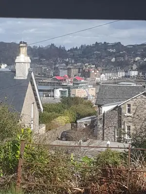 a lighthouse on top of a house with a city at McCaig's View in Oban