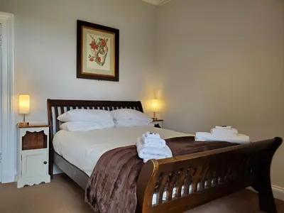a bedroom with a bed with towels on it at McCaig's View in Oban