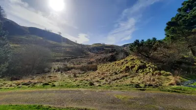 a view of a grassy hill with a river at Jura in Oban