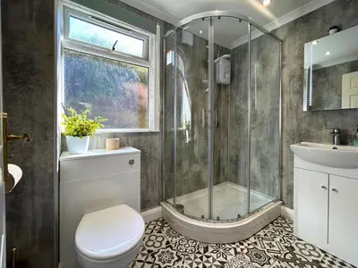 a bathroom with a shower and a toilet and a sink at Jura in Oban
