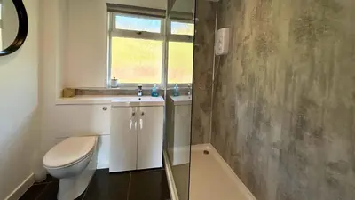 a bathroom with a toilet and a sink and a shower at Skye in Oban