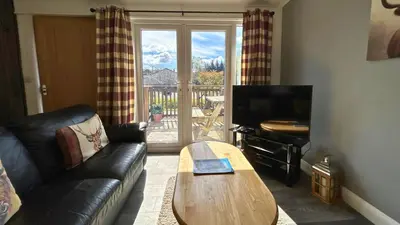 a living room with a couch and a coffee table at Skye in Oban