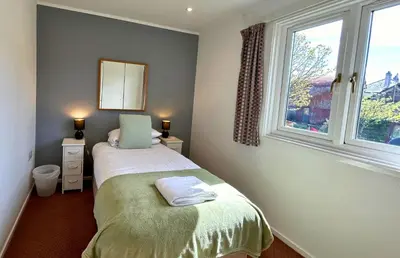 a small bedroom with a bed and a window at Skye in Oban