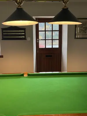 a pool table in a room with two lights at Craigruie Farmhouse in Balquhidder