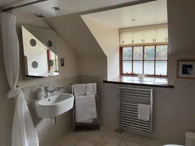 a bathroom with a sink and a window at Craigruie Farmhouse in Balquhidder