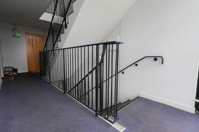 an empty room with a staircase and a door at Whiteside Apartment in Bathgate