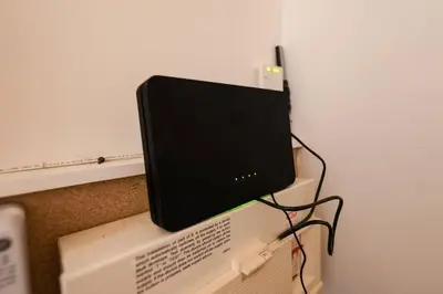 a computer monitor sitting on top of a computer tower at Whiteside Apartment in Bathgate