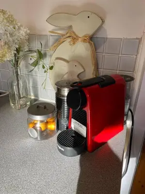 a red toaster sitting on top of a kitchen counter at Christmas Cottage in Balmaha