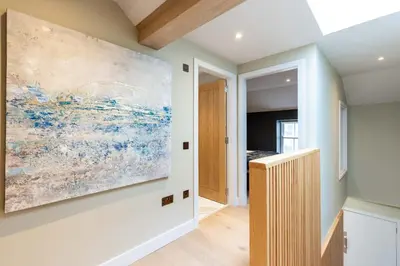 a hallway with a large painting on the wall at Dragon Suites - City Centre 2 Bed Luxury Mews House in Edinburgh