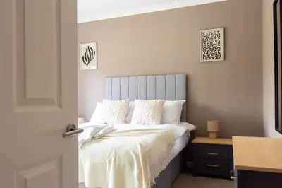 a bedroom with a bed with white sheets and pillows at Burns House in Livingston