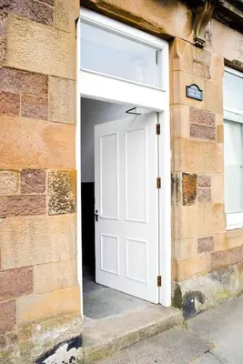 a white door in a brick building with a window at 6 Killean Place in Campbeltown