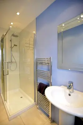 a bathroom with a glass shower and a sink at 6 Killean Place in Campbeltown