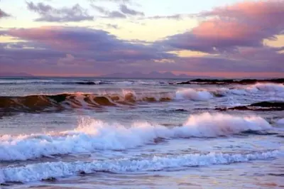 a group of waves in the ocean at sunset at 6 Killean Place in Campbeltown