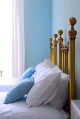a bed with a bunch of pillows on it at 6 Killean Place in Campbeltown