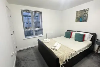 a bedroom with a bed in a white room at 4 Bed complete Home in Edinburgh Near Airport in Edinburgh