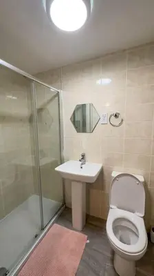 a bathroom with a toilet and a sink and a shower at 4 Bed complete Home in Edinburgh Near Airport in Edinburgh