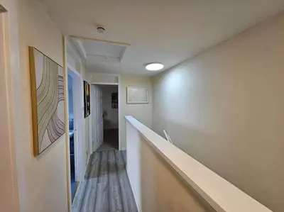 a hallway with a long stairway with a hallway at 4 bed house With 6 Beds in Edinburgh