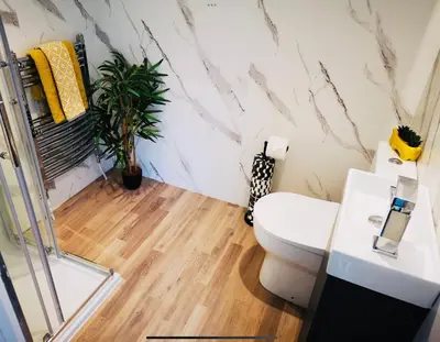 a bathroom with a white toilet and a mirror at Harling House - Prestwick - 4 bedrooms in Prestwick