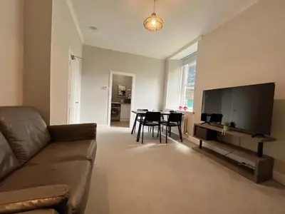 a living room with a couch and a table at Two bed apartment in Edinburgh