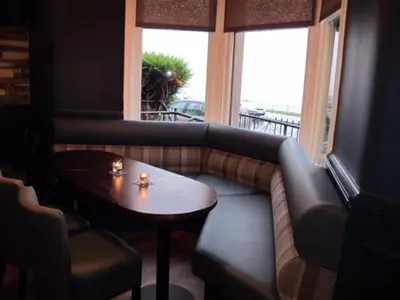 a living room with a couch and a table at The Spinnaker Hotel in Gourock