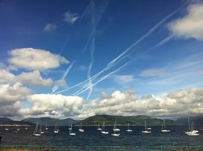 a group of sailboats in the water under a cloudy sky at The Spinnaker Hotel in Gourock