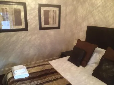 a hotel room with a bed and two pictures on the wall at The Spinnaker Hotel in Gourock
