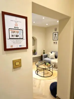 a living room with a couch and a table at Newly Renovated Gem - Free Parking & Modern Comfort in Glasgow