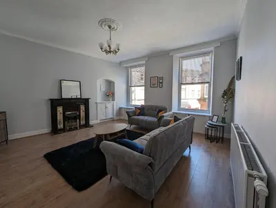 a living room with a couch and a table at Campbeltown Central in Campbeltown