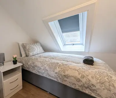 a bedroom with a bed and a window at Campbeltown Central in Campbeltown