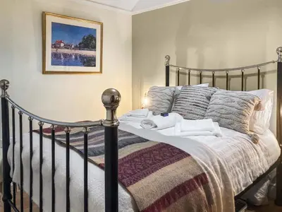 a bedroom with a bed with towels on it at Darroch in Moniaive
