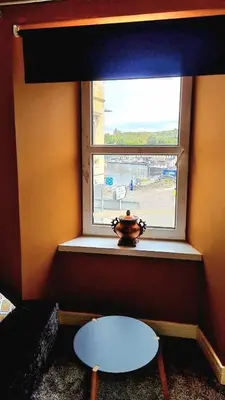 a window with a table in front of it at The Rest in Tarbert