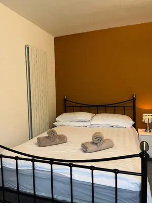 a bedroom with a bed with two towels on it at The Rest in Tarbert