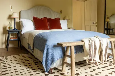 a bedroom with a large bed with red pillows at Penicuik Estate in Penicuik