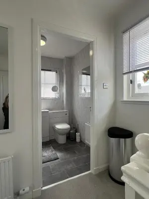 a white bathroom with a toilet and a window at No 6, Ayr, 140m2, New Decor 2024, 3bedroom, detached house, with private gardens in Ayr