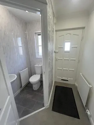 a white bathroom with a toilet and a sink at No 6, Ayr, 140m2, New Decor 2024, 3bedroom, detached house, with private gardens in Ayr