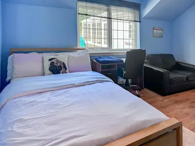 a bedroom with a bed with a dog pillow on it at Nether Auchlinsky Cottage in Glendevon