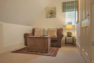 a living room with a couch and a table at Alexander House 24 - Self Catering in Auchterarder