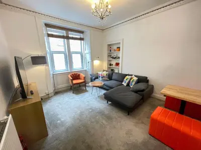 a living room with a couch and a table at Lovely two bedrooms in Edinburgh